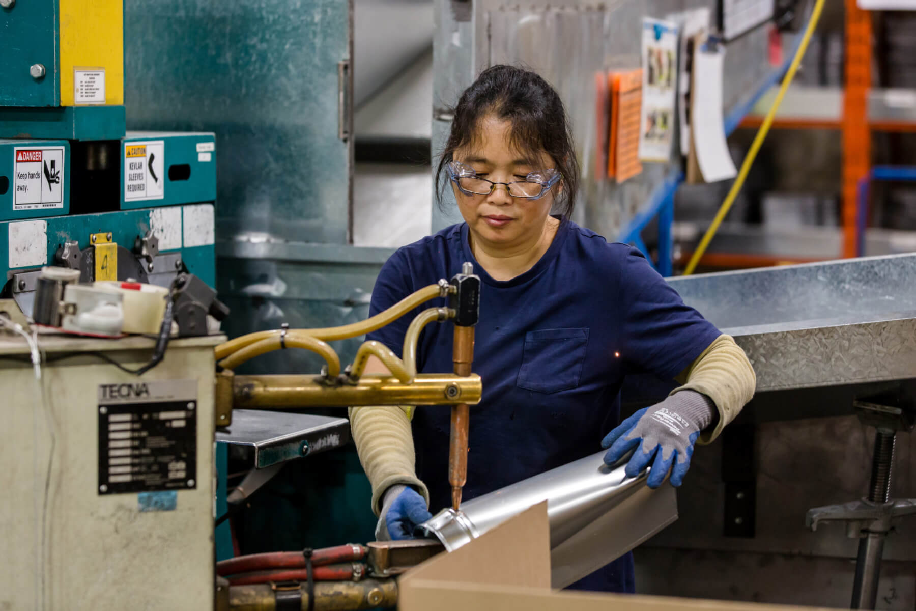 Tradesman Employee working on a HVAC Part